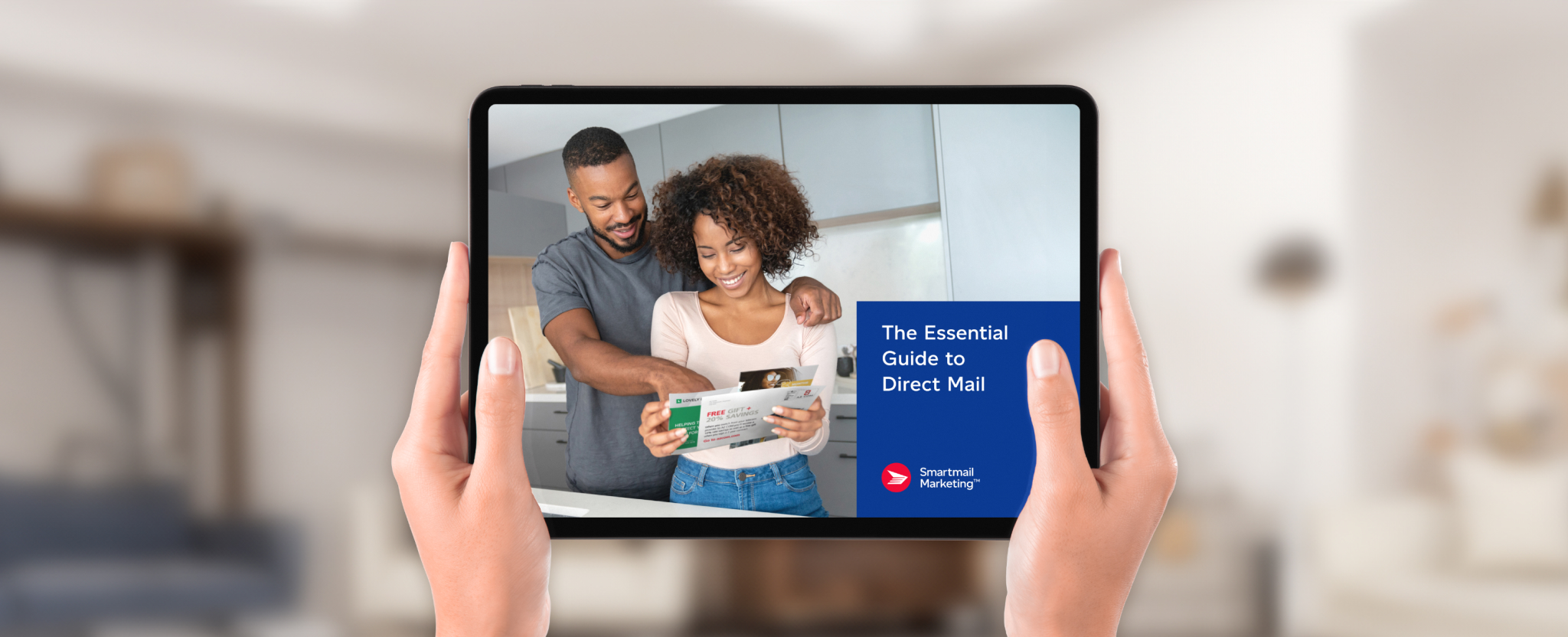 A person holds a tablet computer that displays the cover of the “Essential guide to direct mail” from Smartmail Marketing™