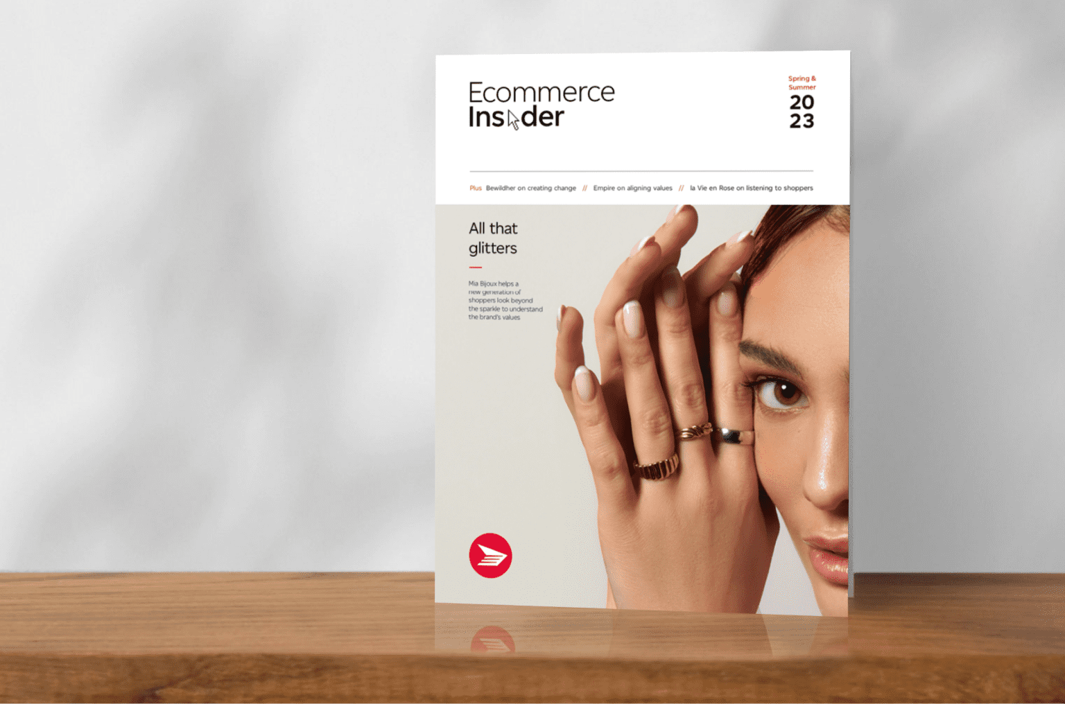 The cover of the spring/summer issue of Ecommerce Insider magazine features a woman holding her hands by her face wearing three rings.